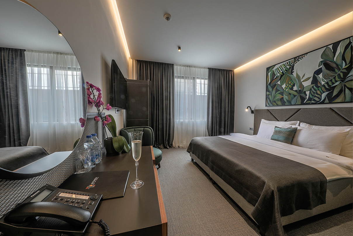 hotel-botanica-superior-double-room-belgrade4 Superior Double Room at Hotel Botanica in Belgrade with double bed, seating area and modern interior